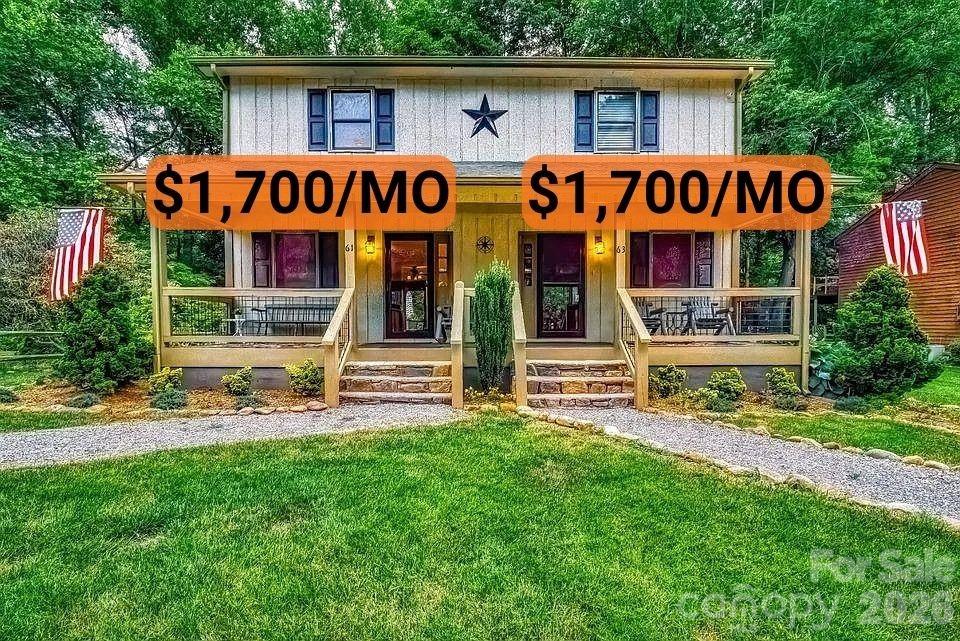 a front view of multi story residential apartment building with yard and outdoor seating