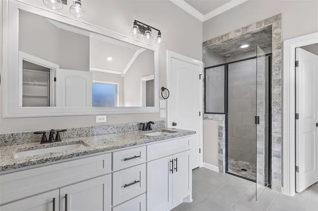 a bathroom with a granite countertop tub sink and mirror