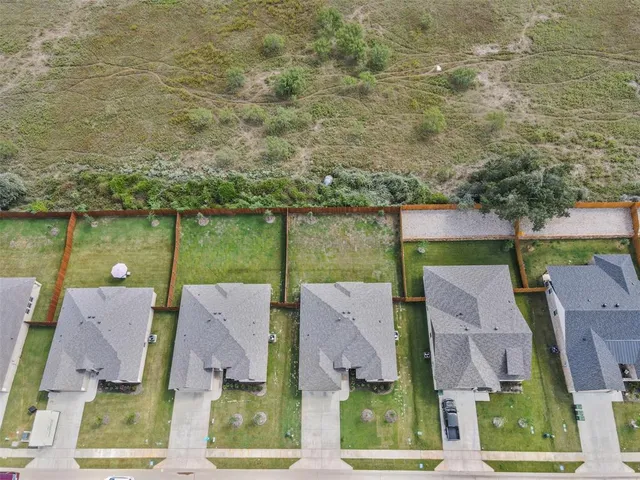 an aerial view of residential houses with outdoor space