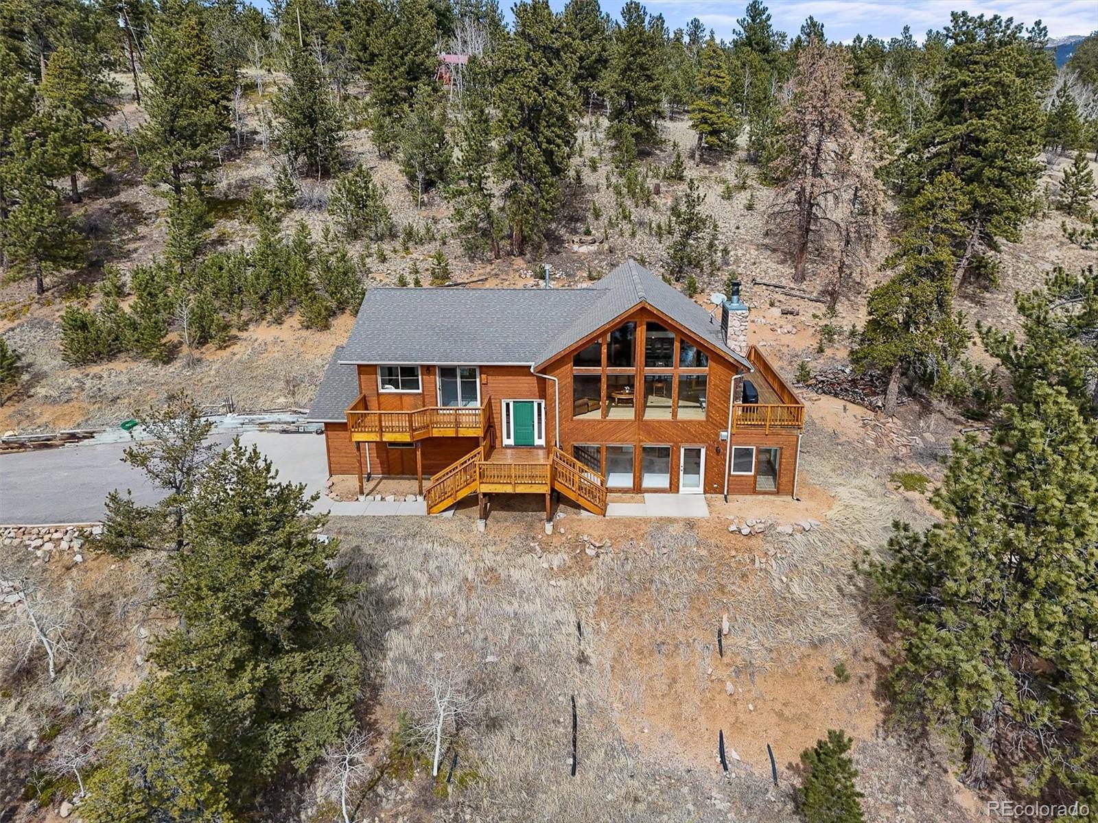 an aerial view of a house with swimming pool and sitting area