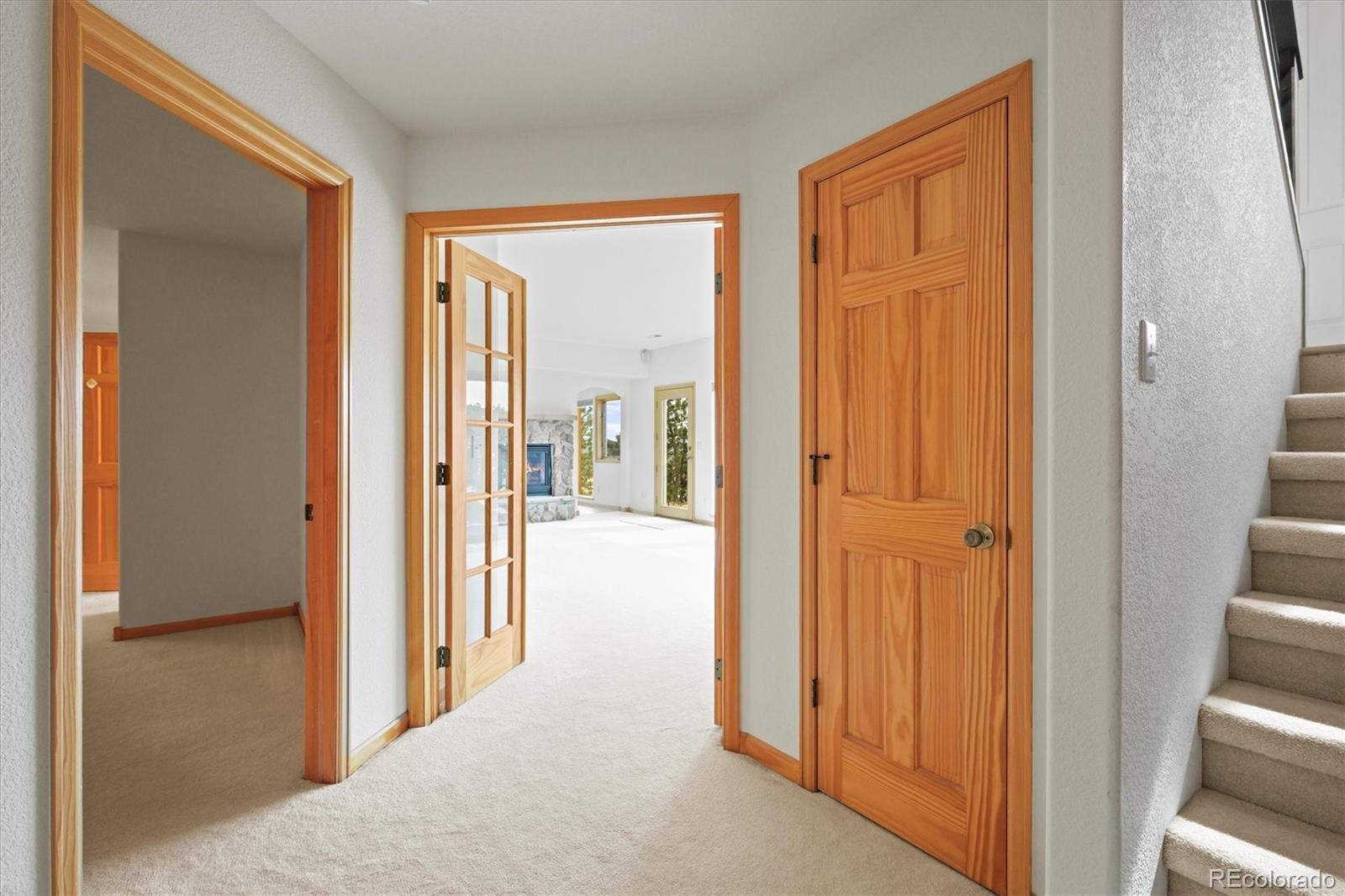 349 Royal Ridge Drive Bailey, CO 80421 - Photo 26 of 45 a view of a hallway with a wooden door