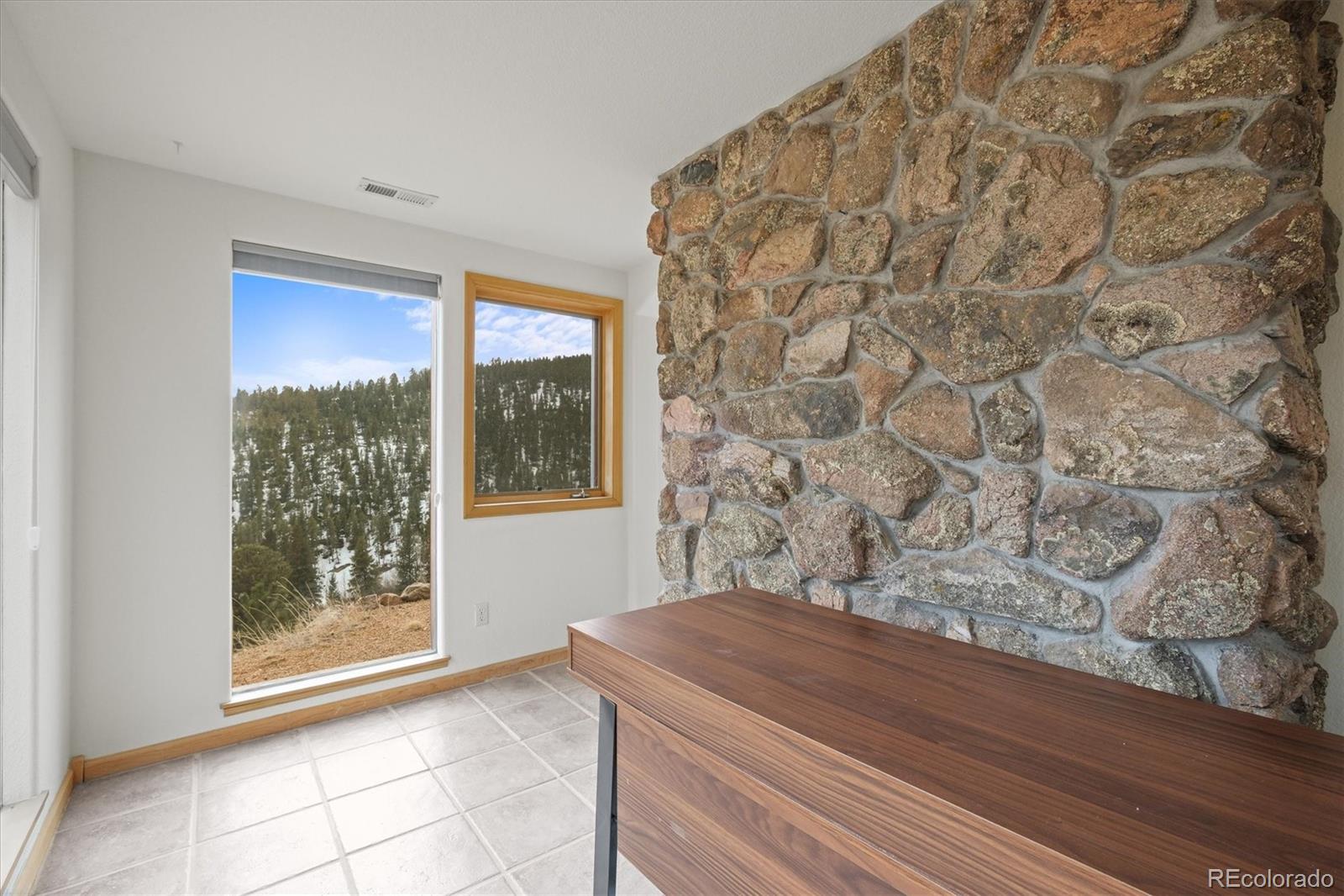 349 Royal Ridge Drive Bailey, CO 80421 - Photo 33 of 45 a room with a bed and a window