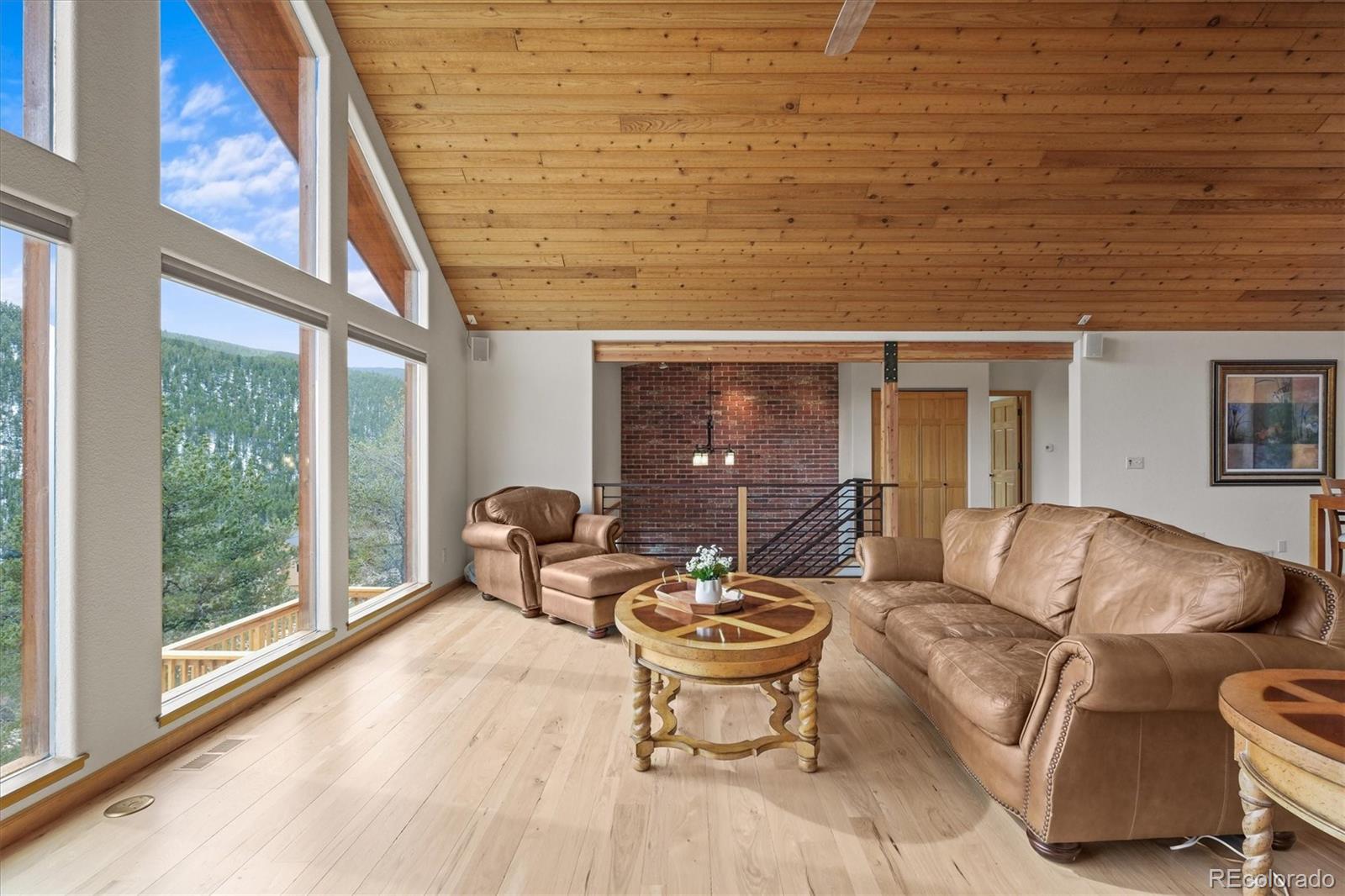 349 Royal Ridge Drive Bailey, CO 80421 - Photo 7 of 45 a living room with furniture and a floor to ceiling window