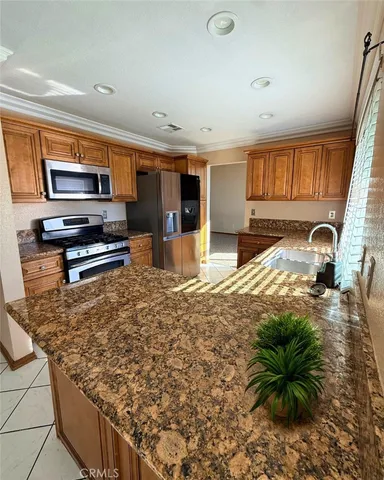 a kitchen with sink refrigerator and microwave