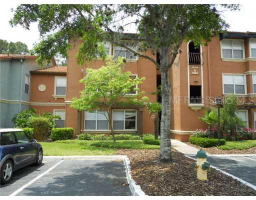 5152 Conroy Road, Unit 1312 Orlando, FL 32811 - Photo 1 of 1 a view of a car parked in front of a brick house with large windows