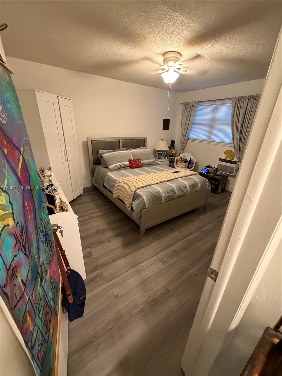 3500 Harrison Street, Unit 4 Hollywood, FL 33021 - Photo 6 of 10 a bedroom with a bed and a large mirror on the dresser
