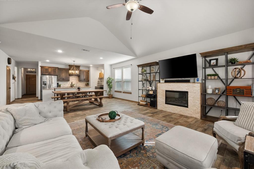 707 Phillips Court Mansfield, TX 76063 - Photo 12 of 28 a living room with furniture a flat screen tv and a fireplace