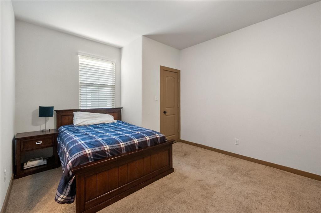 707 Phillips Court Mansfield, TX 76063 - Photo 19 of 28 a bedroom with a bed and a tv