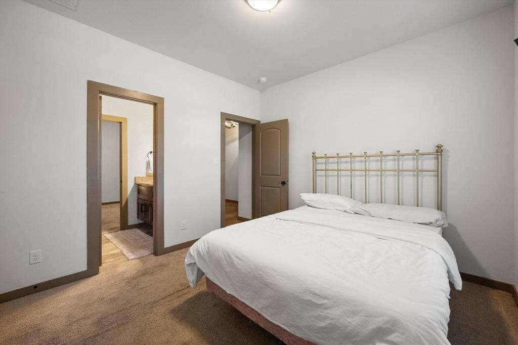 707 Phillips Court Mansfield, TX 76063 - Photo 22 of 28 a large bed sitting in a bedroom and a bathroom