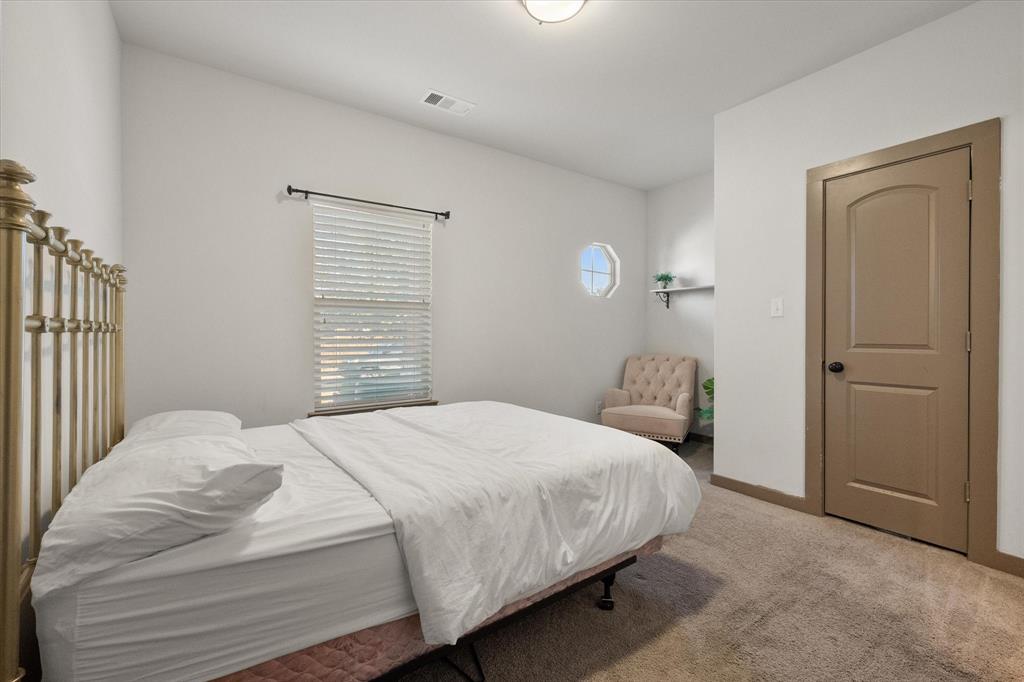 707 Phillips Court Mansfield, TX 76063 - Photo 23 of 28 a bedroom with a bed and a cabinets