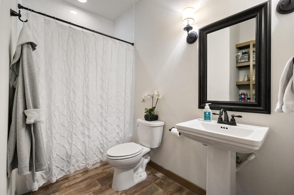 707 Phillips Court Mansfield, TX 76063 - Photo 24 of 28 a bathroom with a sink a toilet and shower