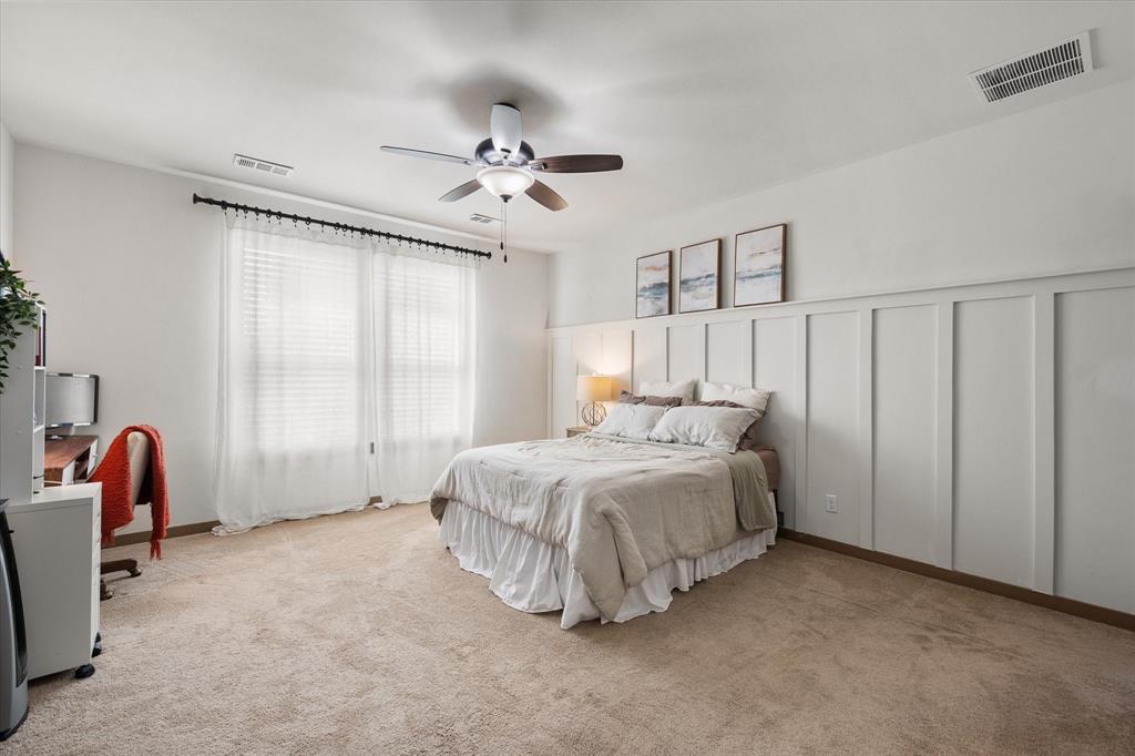 707 Phillips Court Mansfield, TX 76063 - Photo 25 of 28 a spacious bedroom with a bed and a window