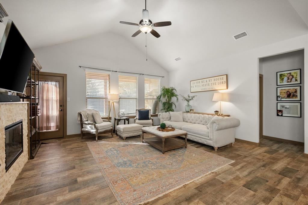 707 Phillips Court Mansfield, TX 76063 - Photo 9 of 28 a living room with furniture ceiling fan and a flat screen tv