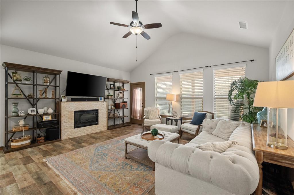 707 Phillips Court Mansfield, TX 76063 - Photo 10 of 28 a living room with furniture a fireplace and a flat screen tv