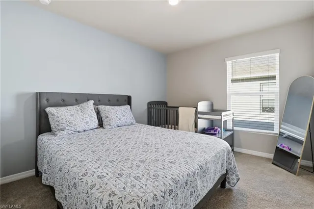 a large bed sitting in a bedroom next to a window with tv