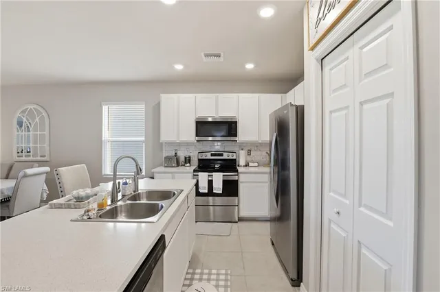 a kitchen with a sink a stove and refrigerator