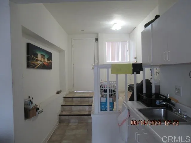 a kitchen with granite countertop a sink and cabinets