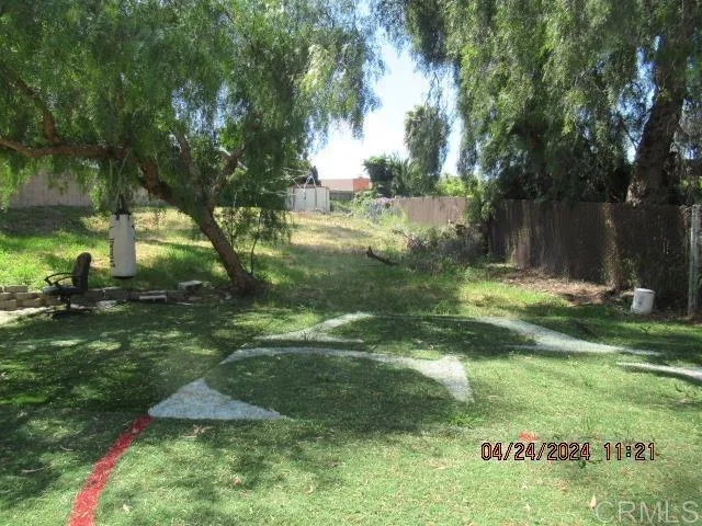 a backyard of a house with a yard and outdoor seating