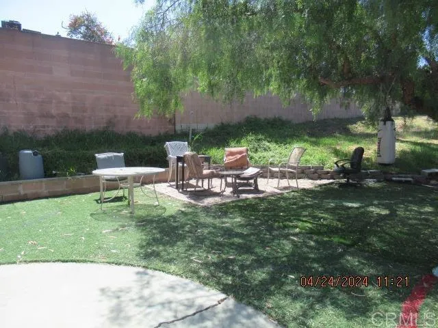 a backyard of a house with table and chairs