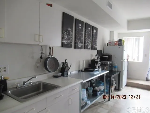 a kitchen with a sink stove and cabinets
