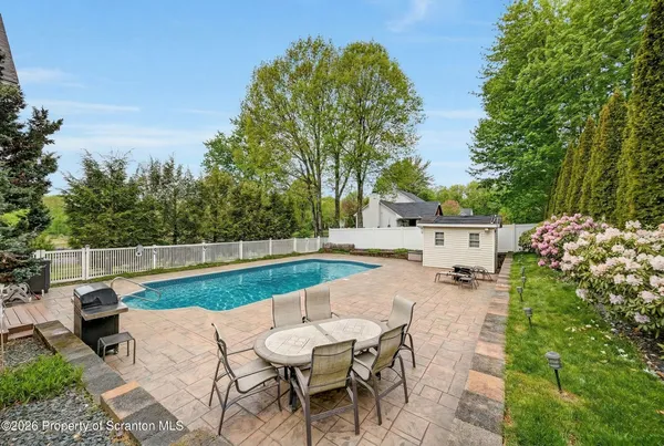 a living room with furniture and a flat screen tv with kitchen view