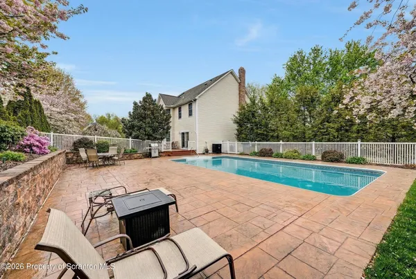 a view of a dining room with furniture a kitchen and chandelier