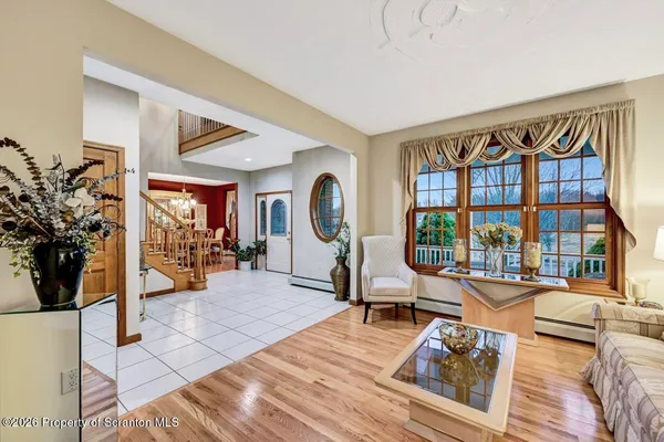 a view of entryway with wooden floor and windows