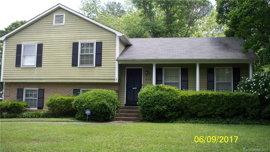 6029 Powder Horn Road Charlotte, NC 28212 - Photo 1 of 3 a view of a house with a yard plants and large tree