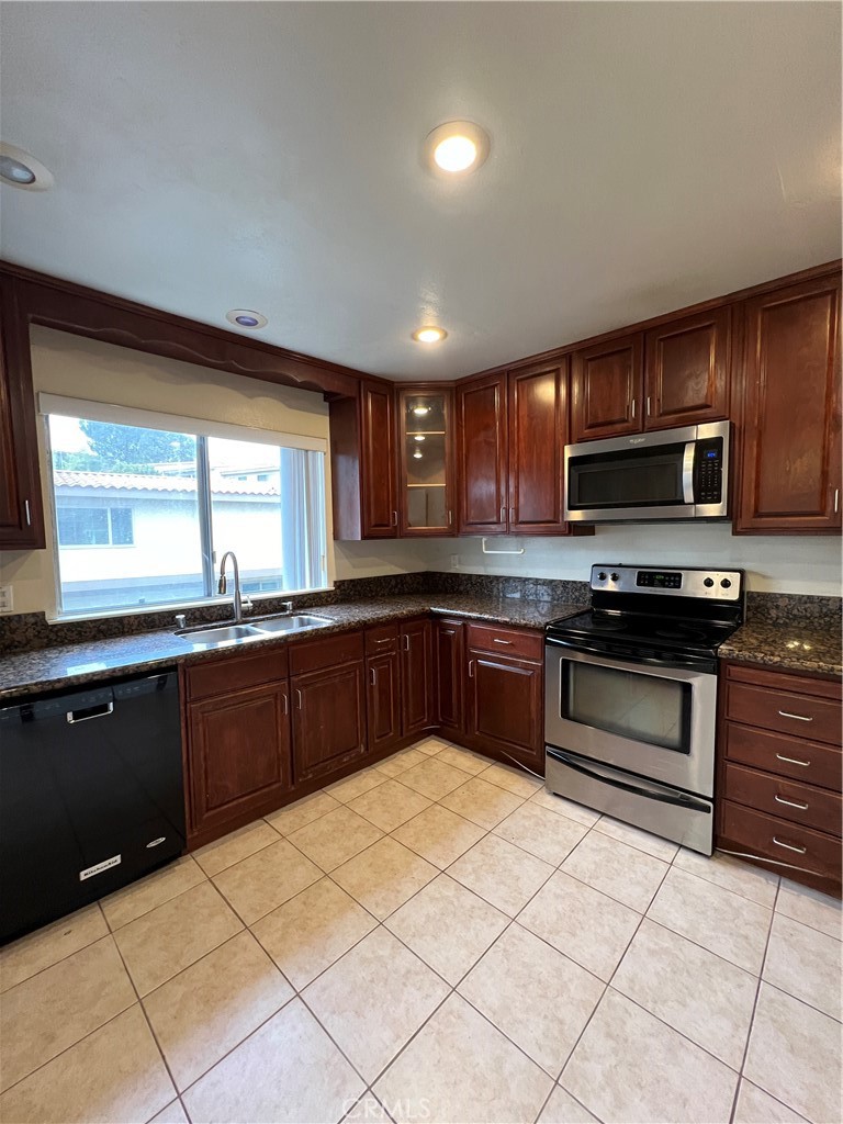 28129 Ridgethorne Court, Unit 34 Rancho Palos Verdes, CA 90275 - Photo 22 of 27 a kitchen with stainless steel appliances granite countertop a stove sink and cabinets