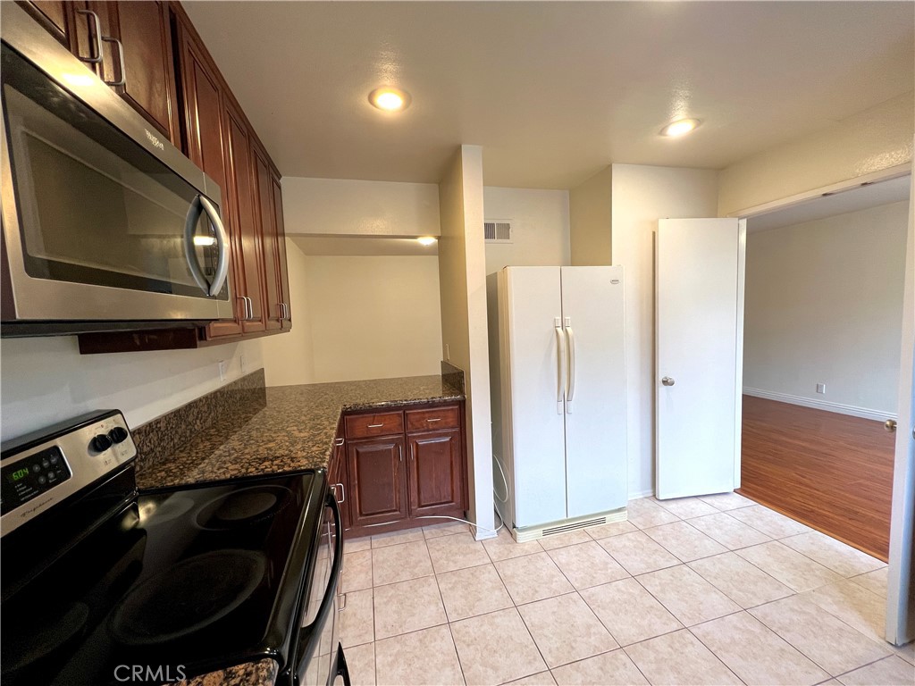 28129 Ridgethorne Court, Unit 34 Rancho Palos Verdes, CA 90275 - Photo 23 of 27 a kitchen with stainless steel appliances granite countertop a stove a refrigerator and a microwave