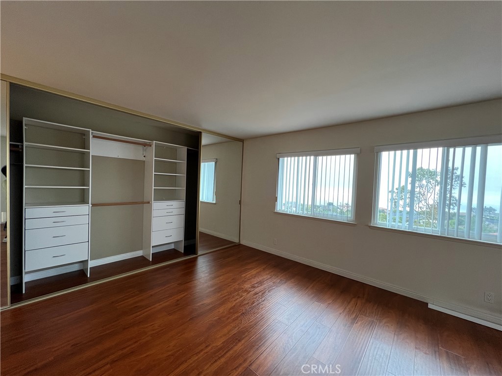 28129 Ridgethorne Court, Unit 34 Rancho Palos Verdes, CA 90275 - Photo 5 of 27 an empty room with wooden floor and windows