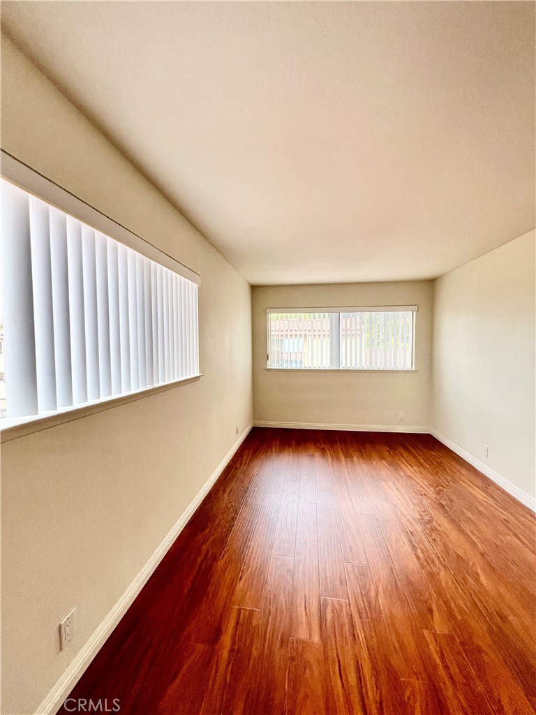 28129 Ridgethorne Court, Unit 34 Rancho Palos Verdes, CA 90275 - Photo 8 of 27 an empty room with wooden floor and windows