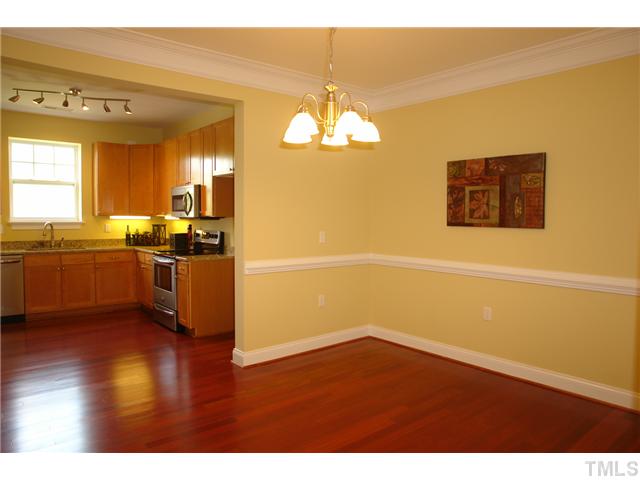 3811 Lunceston Way, Unit 203 Raleigh, NC 27613 - Photo 11 of 20 a kitchen with stainless steel appliances a stove a sink and a refrigerator