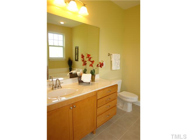 3811 Lunceston Way, Unit 203 Raleigh, NC 27613 - Photo 15 of 20 a bathroom with a sink a toilet and mirror