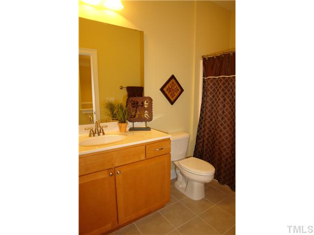 3811 Lunceston Way, Unit 203 Raleigh, NC 27613 - Photo 18 of 20 a bathroom with a toilet sink and mirror