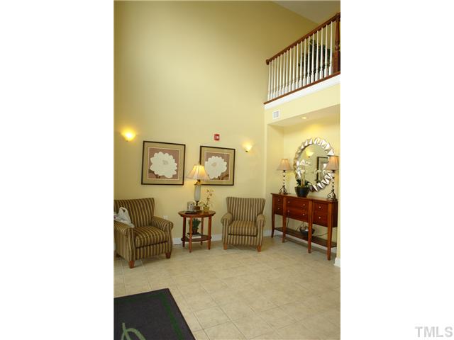 3811 Lunceston Way, Unit 203 Raleigh, NC 27613 - Photo 3 of 20 a balcony with chairs and a potted plant