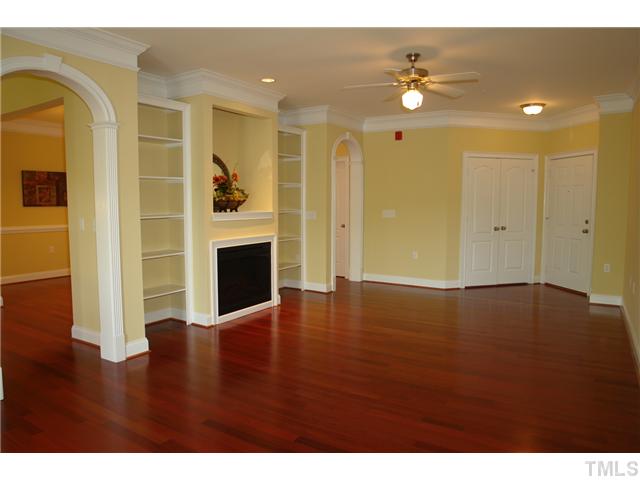 3811 Lunceston Way, Unit 203 Raleigh, NC 27613 - Photo 6 of 20 a view of an empty room with wooden floor and a window