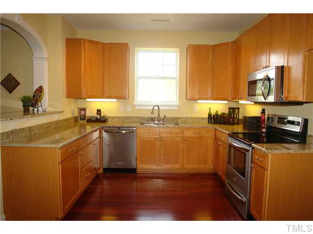 3811 Lunceston Way, Unit 203 Raleigh, NC 27613 - Photo 10 of 20 a kitchen with a sink stove top oven and microwave