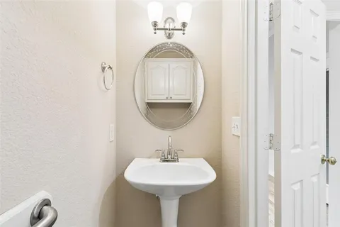 a bathroom with a sink a mirror and vanity