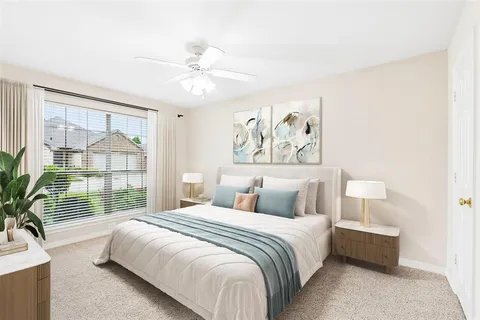 a bedroom with a large bed and a chandelier