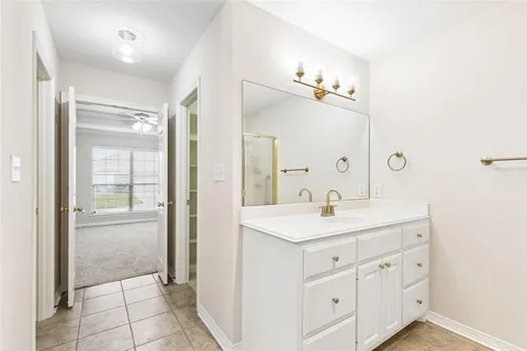 a bathroom with a sink a light fixture a vanity and a mirror
