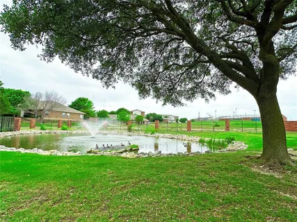 a view of a lake with houses in the back