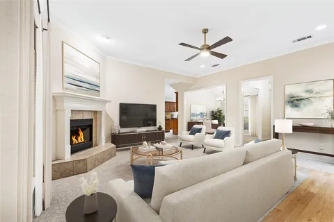 a living room with furniture a fireplace and a flat screen tv