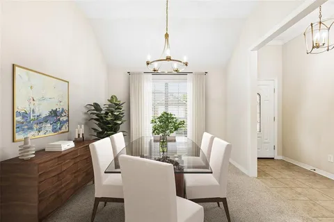 a dining room with furniture wooden floor and a chandelier