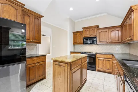 a kitchen with stainless steel appliances granite countertop a stove top oven a sink dishwasher and a microwave oven on the blue kitchen countertops
