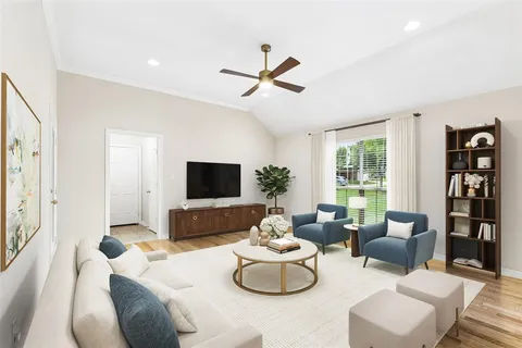 a living room with furniture and a flat screen tv
