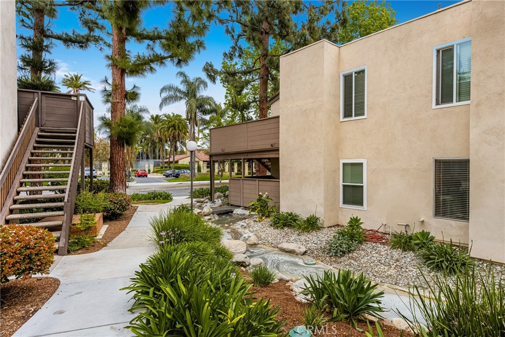 1420 E Cabrillo Park Drive, Unit E Santa Ana, CA 92701 - Photo 13 of 46 a view of a house with a yard and potted plants