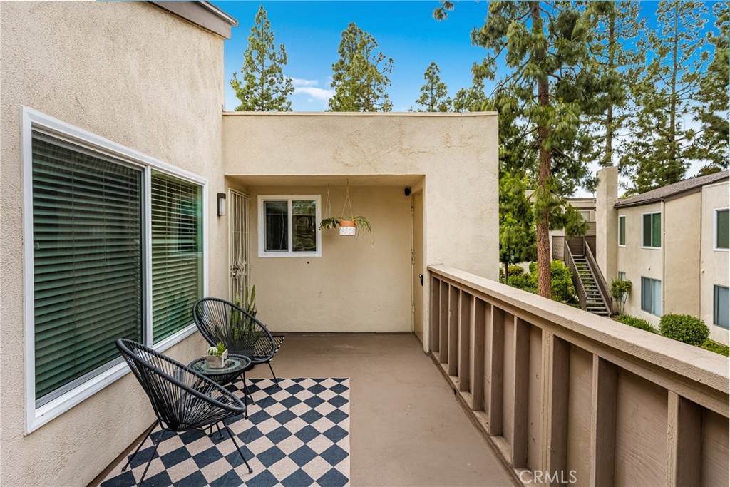 1420 E Cabrillo Park Drive, Unit E Santa Ana, CA 92701 - Photo 14 of 46 a view of a chair and table in the balcony