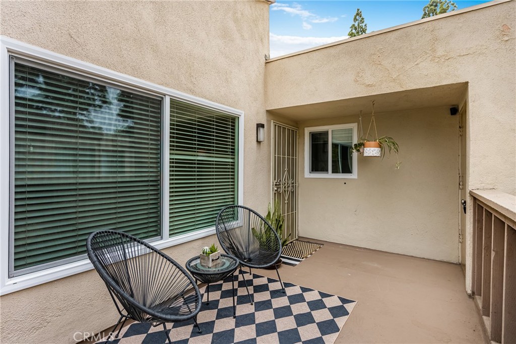 1420 E Cabrillo Park Drive, Unit E Santa Ana, CA 92701 - Photo 15 of 46 a view of a chair and table in back of the house