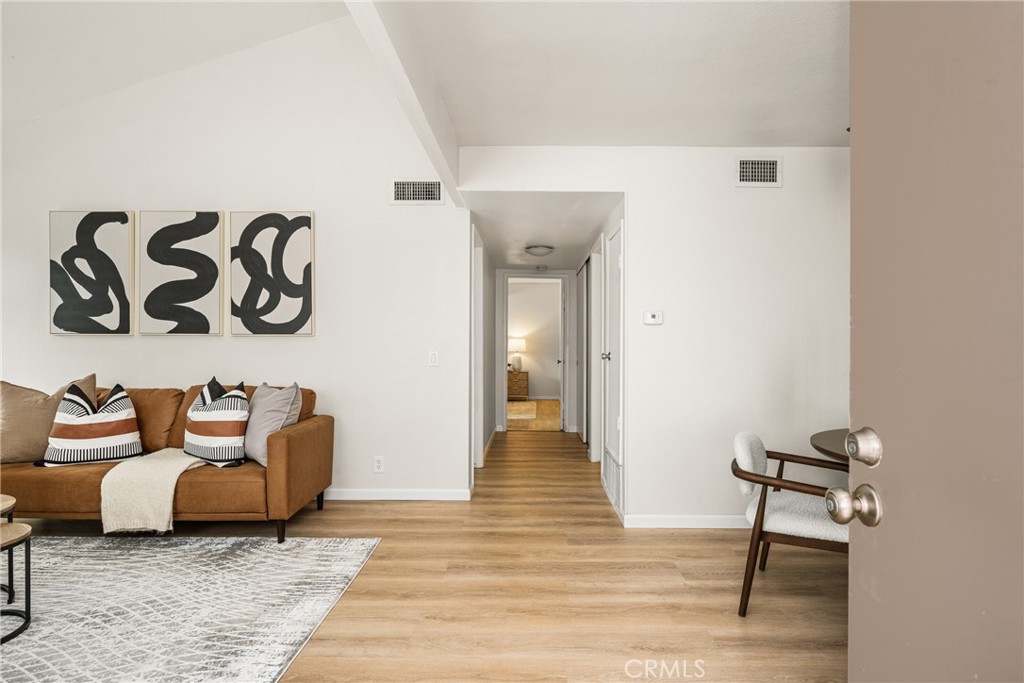 1420 E Cabrillo Park Drive, Unit E Santa Ana, CA 92701 - Photo 16 of 46 a living room with furniture and a wooden floor